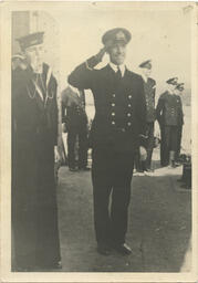 [George Whalley in uniform on ship deck]
