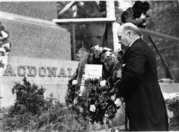 Mackenzie King laying wreath on monument to Sir John A. Macdonald - V25.5-45-3