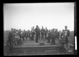 [Wolfe Island Band Performing on a Wooden Stage in a Field]