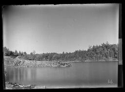 [A Bay Lined with Trees and a Mine Dock]