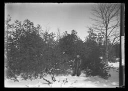 [Man In Woods Dressed For Cold Weather In A Fur Coat]