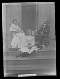 [Man, Woman and Girl On A Porch with a Cat]