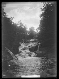[Man and Woman Beside a Rapid Stream]