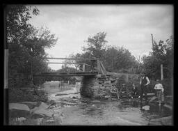 Five Men and a Boy Fishing Beside an Old Bridge]