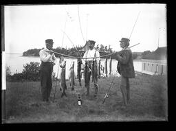 Three Fishermen with a Good Catch]